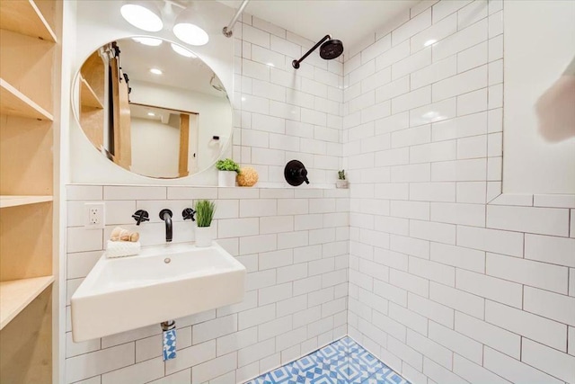 bathroom featuring tasteful backsplash, sink, and tiled shower