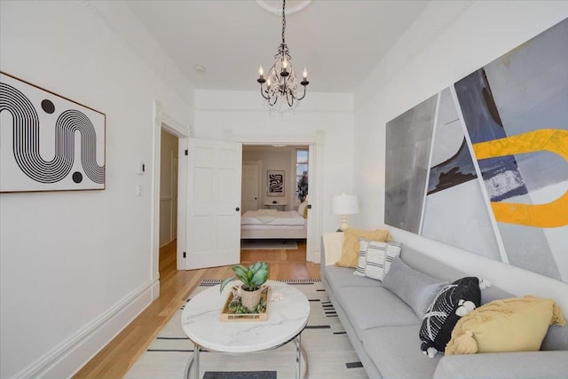 living room with a chandelier and light hardwood / wood-style flooring