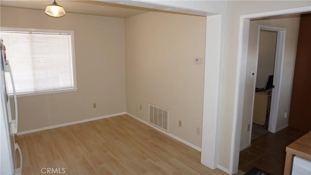 spare room featuring light hardwood / wood-style flooring