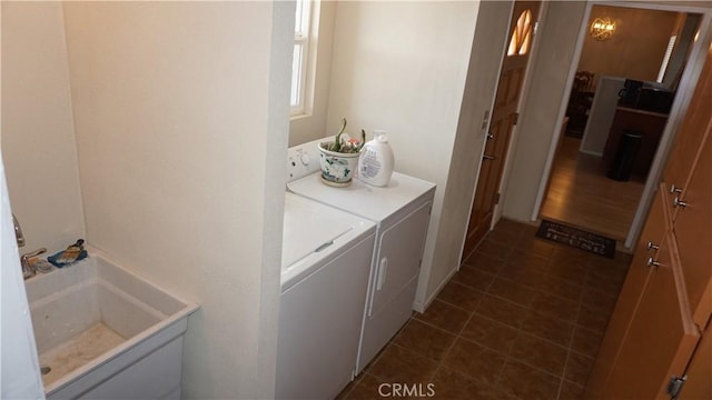 washroom with sink and washing machine and clothes dryer