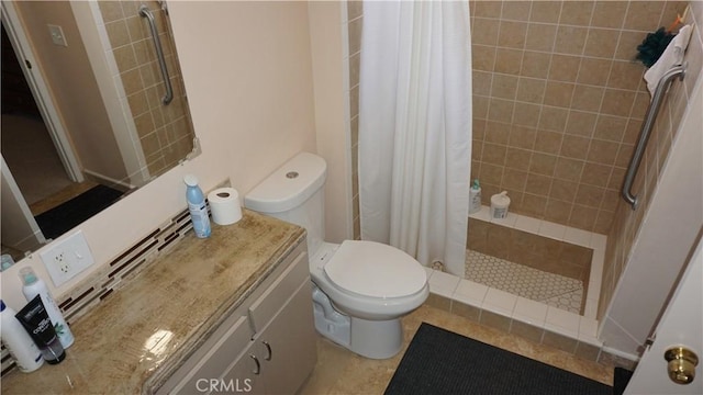 bathroom featuring toilet, vanity, tile patterned floors, and curtained shower