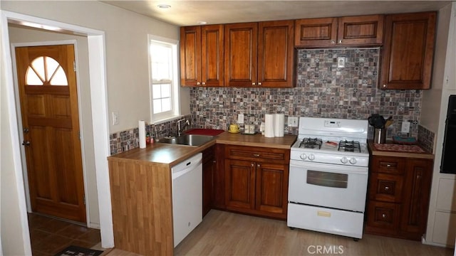 kitchen featuring tasteful backsplash, sink, and white appliances