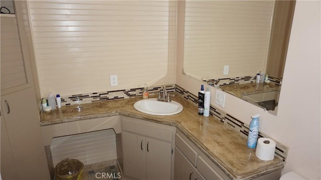 bathroom featuring backsplash and vanity