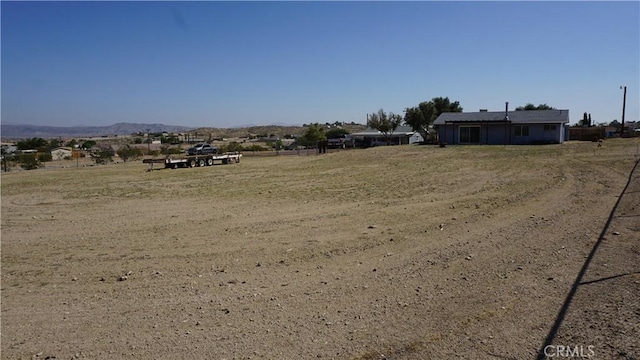 view of yard featuring a mountain view and a rural view