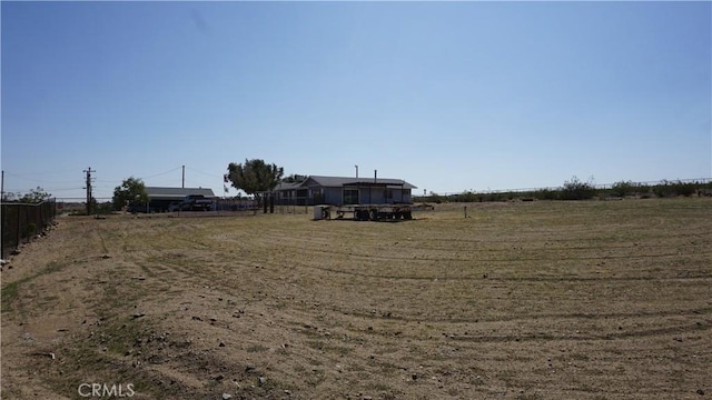 view of yard with a rural view