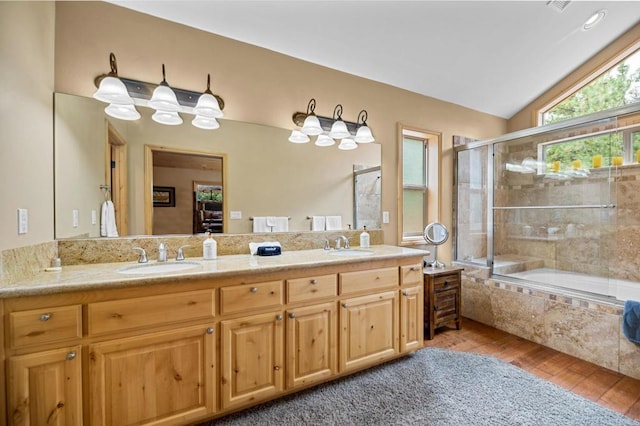 bathroom with shower / bath combination with glass door, dual vanity, lofted ceiling, and hardwood / wood-style floors