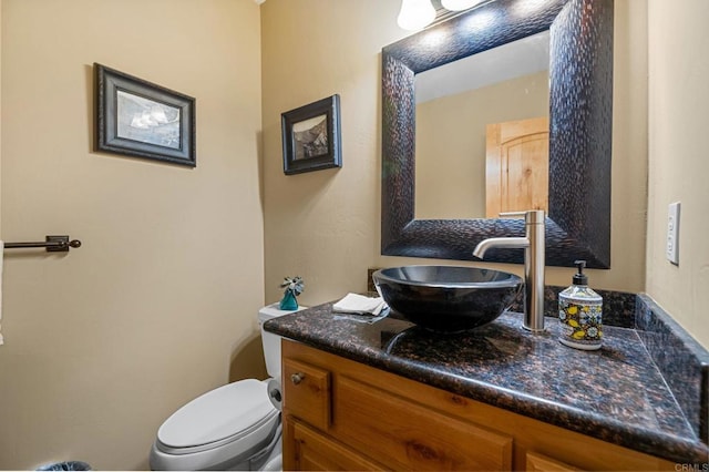 bathroom featuring vanity and toilet