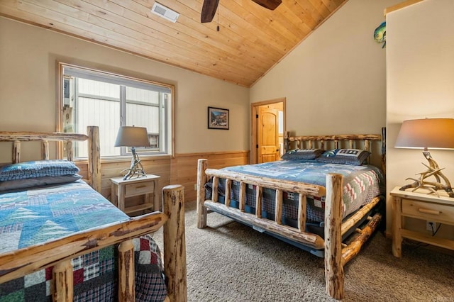 carpeted bedroom with wooden walls, wooden ceiling, ceiling fan, and vaulted ceiling