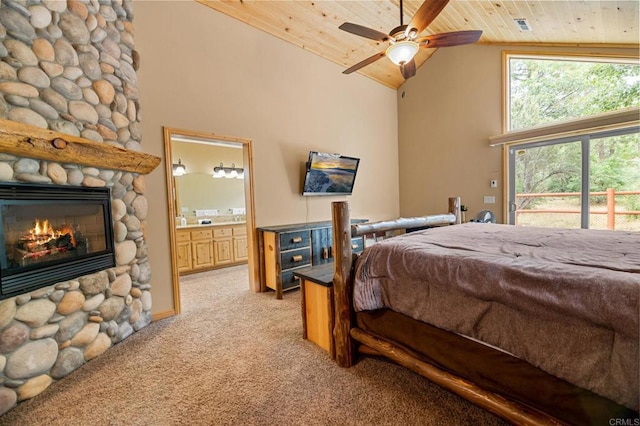 carpeted bedroom with ensuite bathroom, a stone fireplace, high vaulted ceiling, wooden ceiling, and ceiling fan