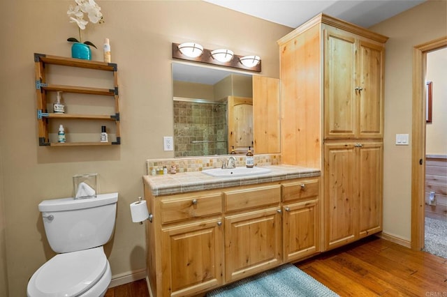 bathroom with wood-type flooring, toilet, and vanity