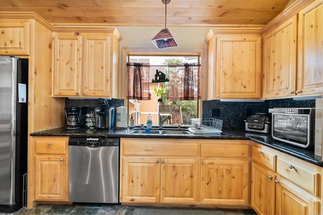 kitchen with sink, dark stone countertops, hanging light fixtures, stainless steel appliances, and decorative backsplash