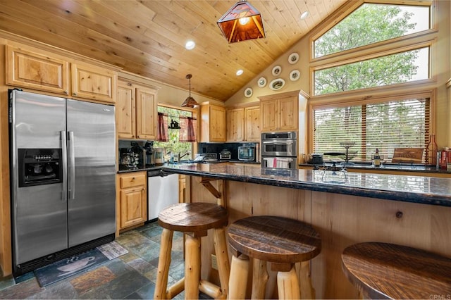 kitchen featuring dark tile patterned floors, stainless steel appliances, hanging light fixtures, decorative backsplash, and high vaulted ceiling