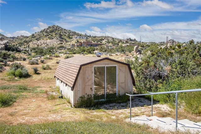 view of outbuilding featuring a mountain view