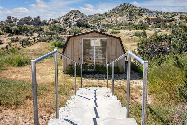 exterior space featuring a mountain view and a storage unit