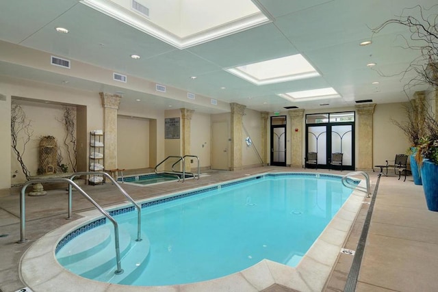 view of pool featuring a skylight