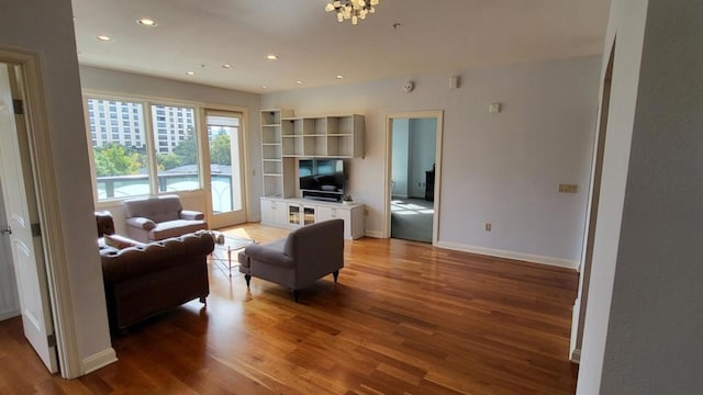 living room featuring a chandelier and wood-type flooring