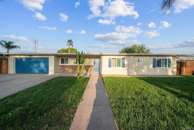 single story home featuring a front lawn and a garage