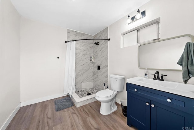 bathroom with toilet, large vanity, walk in shower, and hardwood / wood-style flooring