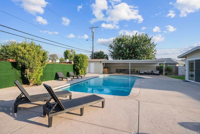 view of swimming pool with a patio area