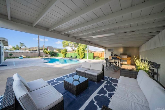 view of patio / terrace featuring area for grilling, a fenced in pool, and an outdoor living space