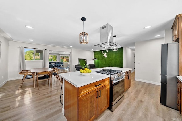 kitchen with hanging light fixtures, light hardwood / wood-style flooring, stainless steel appliances, island range hood, and a kitchen island