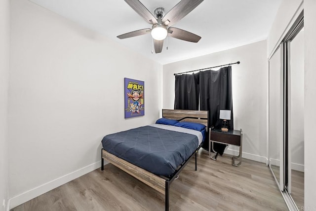 bedroom with ceiling fan and light hardwood / wood-style floors