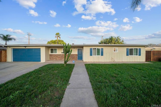 single story home featuring a front lawn and a garage