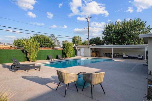 view of swimming pool featuring a lawn and a patio