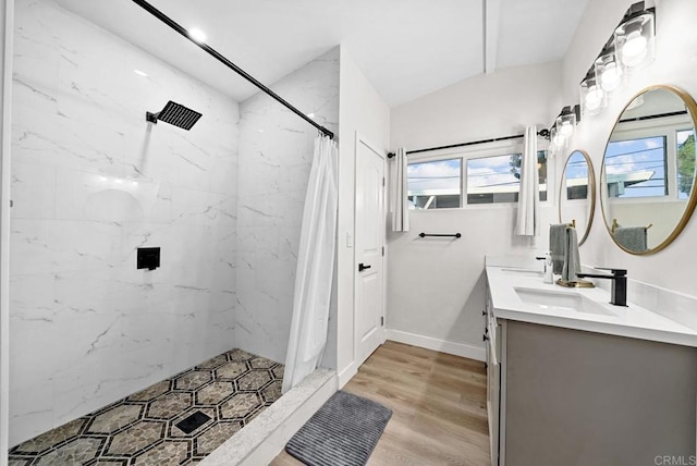 bathroom featuring curtained shower, wood-type flooring, vaulted ceiling, and large vanity