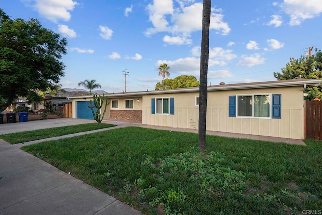 single story home with a front yard and a garage