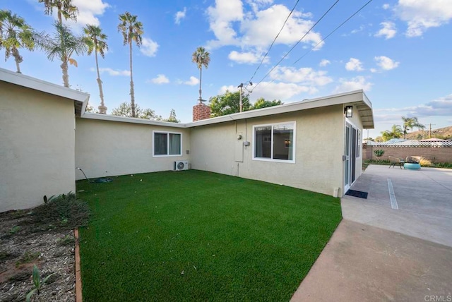 rear view of property featuring a yard and a patio