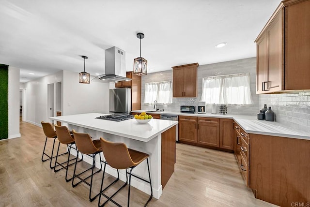 kitchen featuring a kitchen island, light hardwood / wood-style flooring, a kitchen bar, and stainless steel appliances