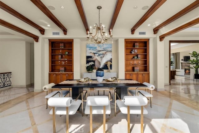 dining space featuring beamed ceiling, an inviting chandelier, and built in features