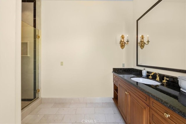 bathroom with tile patterned flooring, vanity, and walk in shower