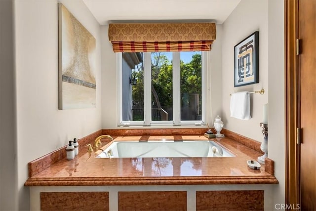 bathroom with a bathing tub and sink