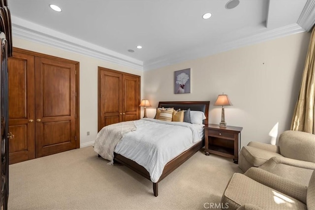 bedroom featuring crown molding and light carpet