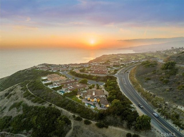 aerial view at dusk with a water view