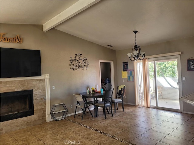 tiled dining room with vaulted ceiling with beams, an inviting chandelier, and a tiled fireplace