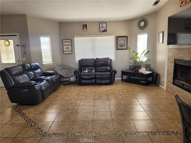 tiled living room featuring a tiled fireplace