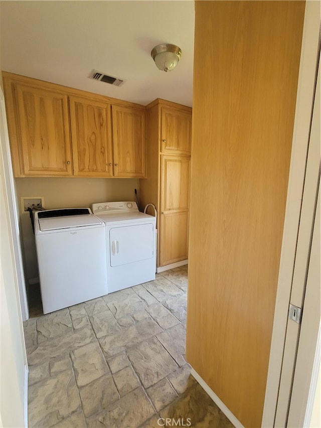 laundry room with washer and clothes dryer, cabinets, washer hookup, and light tile flooring