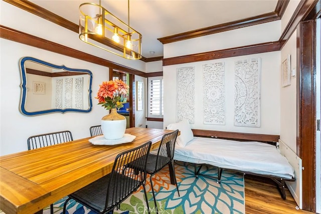 dining area featuring hardwood / wood-style floors and ornamental molding