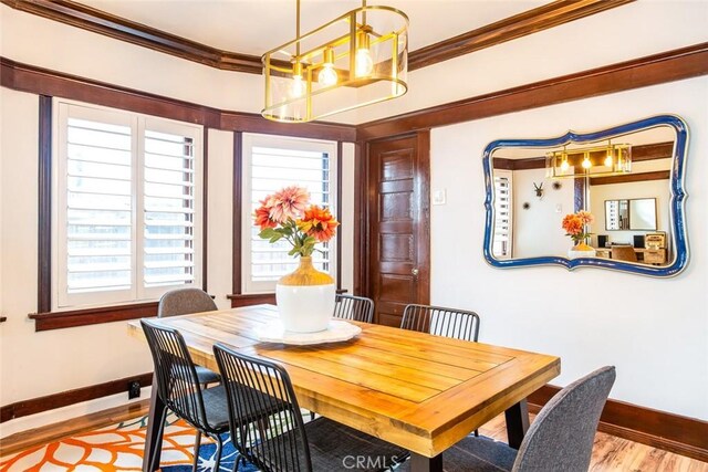 dining room featuring light wood-type flooring and ornamental molding