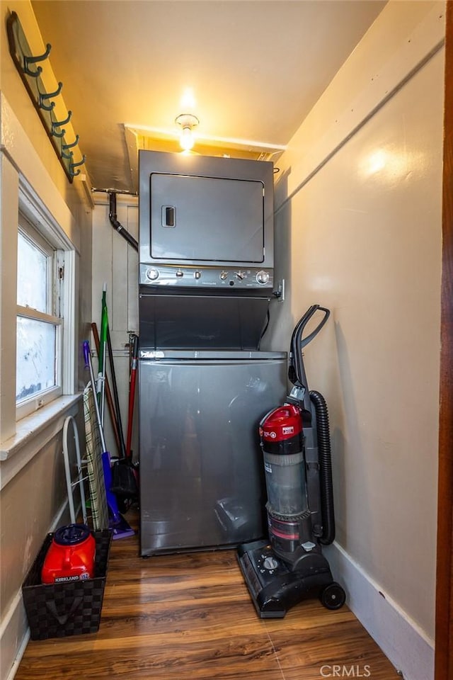 utility room with stacked washer / dryer