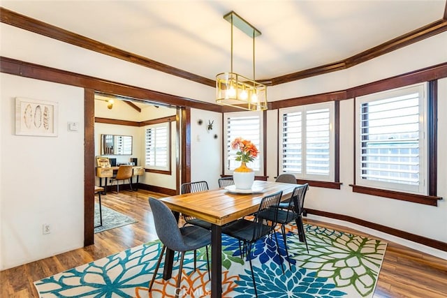 dining area featuring ornamental molding and hardwood / wood-style floors