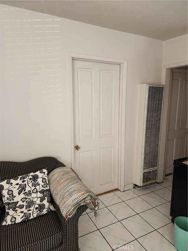 tiled bedroom with a closet