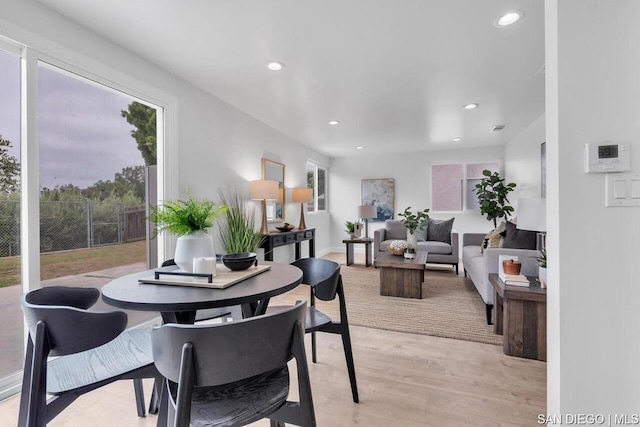 dining space with light hardwood / wood-style flooring