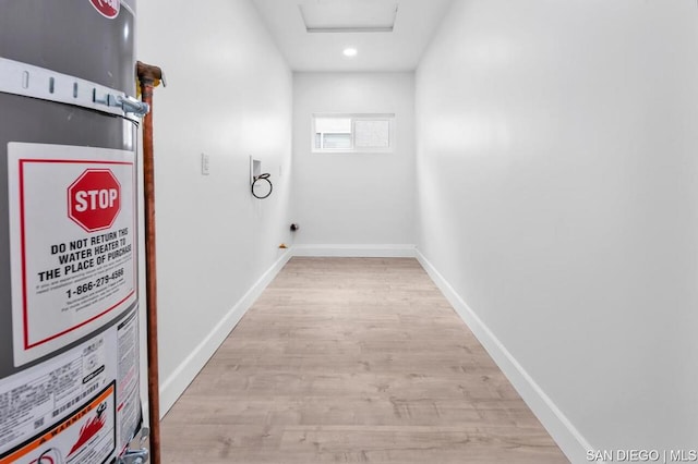 interior space with light hardwood / wood-style flooring and water heater