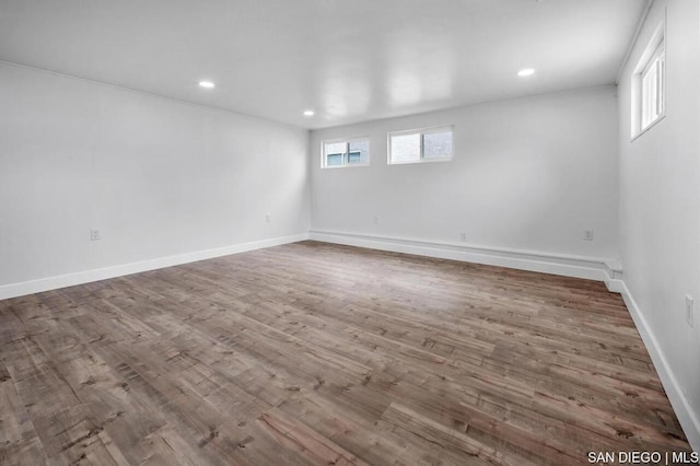 spare room featuring dark wood-type flooring and a healthy amount of sunlight