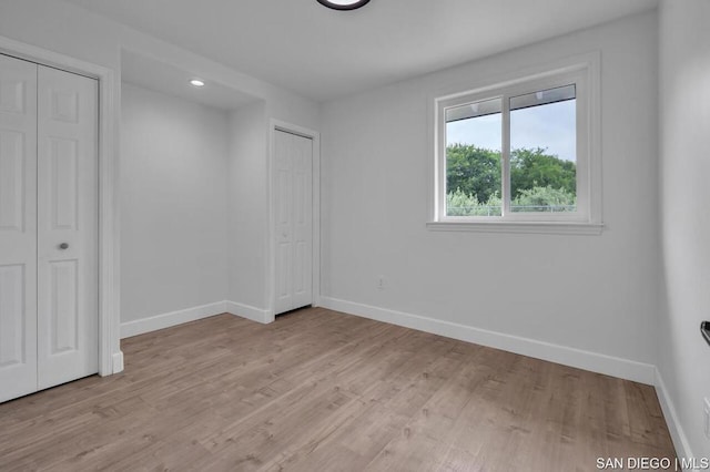 spare room with light hardwood / wood-style floors