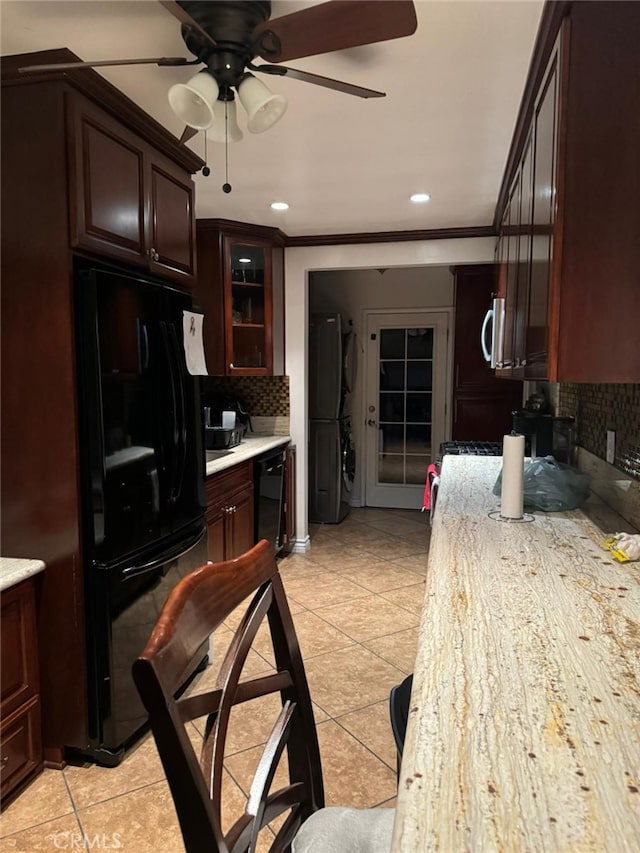 kitchen with ceiling fan, crown molding, decorative backsplash, light tile patterned floors, and black appliances